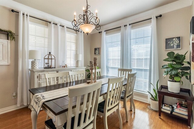 5033 Southpoint Dr, Arlington, TX 76017 - dining room with light wood-style flooring, a chandelier, baseboards, and ornamental molding