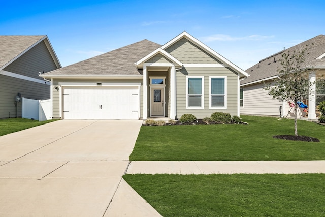 view of front of home featuring a garage, a shingled roof, concrete driveway, fence, and a front yard