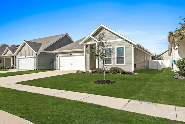 view of front of house featuring an attached garage, fence, concrete driveway, board and batten siding, and a front yard