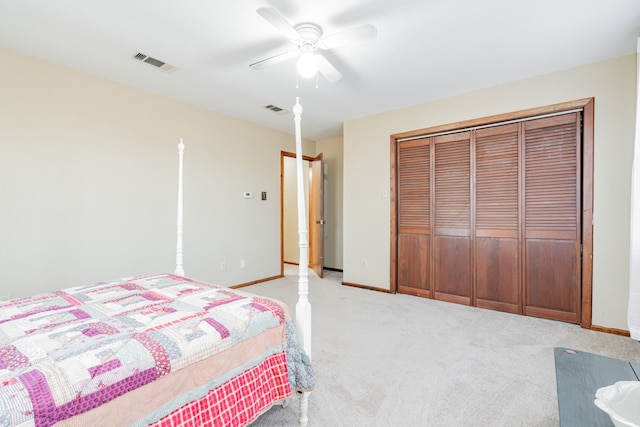 bedroom featuring light colored carpet, a closet, visible vents, and baseboards