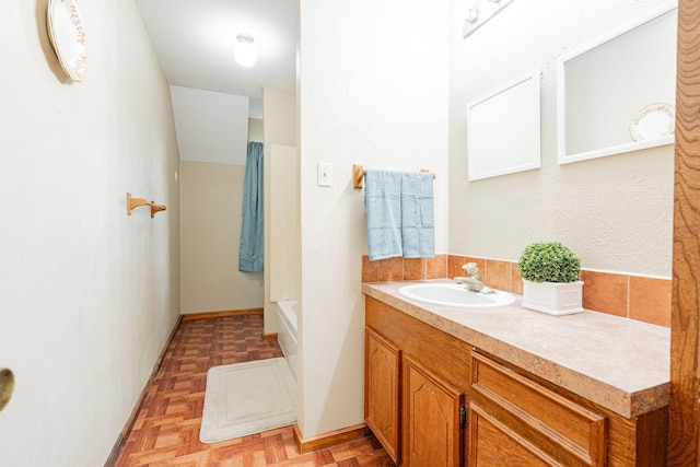 full bathroom with baseboards and vanity