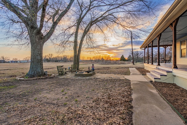 yard at dusk with an outdoor fire pit