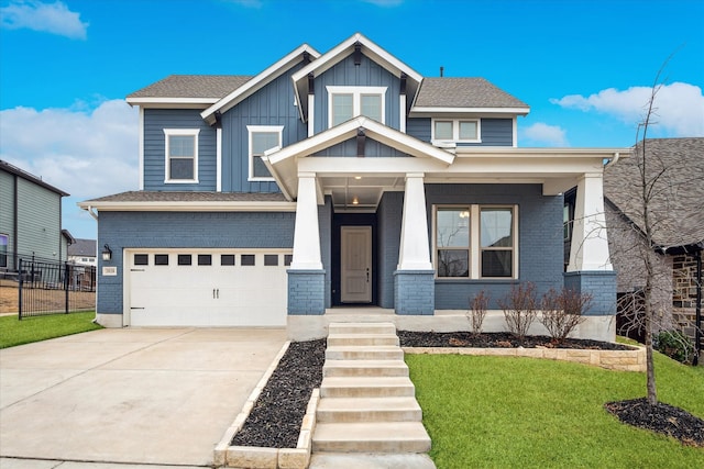 craftsman-style house with a porch, a garage, brick siding, concrete driveway, and board and batten siding