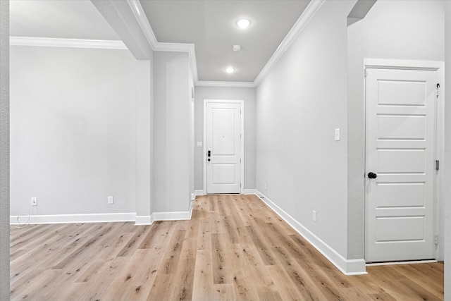 hall with baseboards, light wood finished floors, recessed lighting, and crown molding