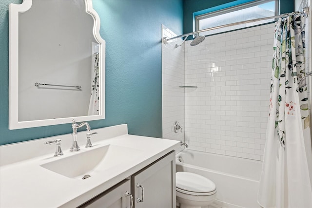 full bathroom featuring a textured wall, shower / tub combo, vanity, and toilet