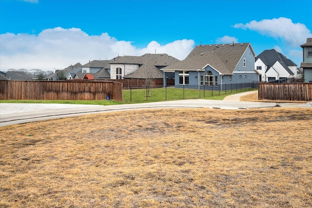 view of yard featuring fence and a residential view