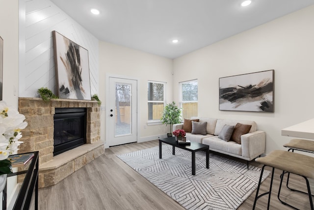 living room with baseboards, a fireplace, wood finished floors, and recessed lighting