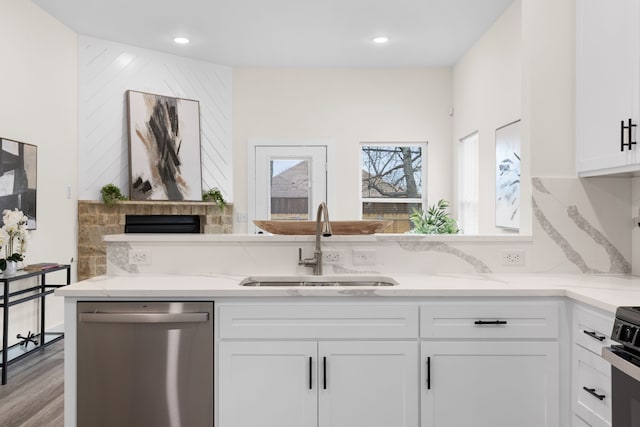 kitchen with a sink, white cabinetry, decorative backsplash, light stone countertops, and dishwasher