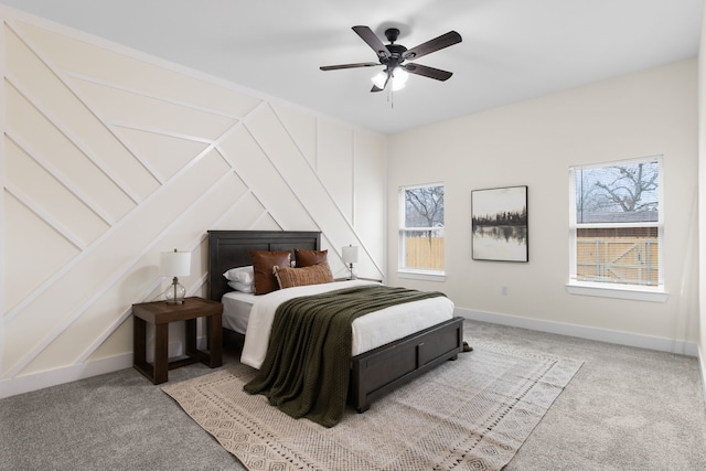 bedroom with baseboards, multiple windows, and light colored carpet