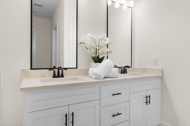 full bathroom with visible vents, a sink, and double vanity