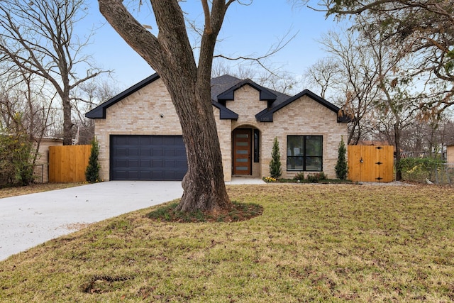 view of front facade featuring driveway, a gate, fence, a front lawn, and brick siding