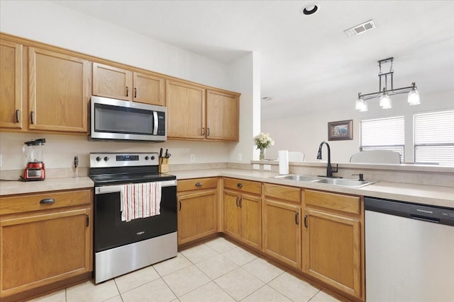 kitchen with light tile patterned floors, a sink, visible vents, light countertops, and appliances with stainless steel finishes