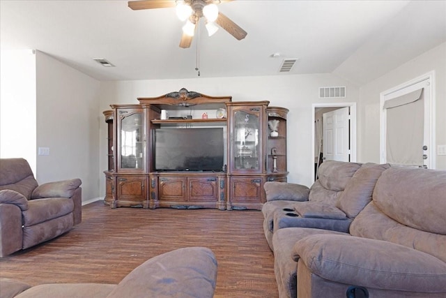 living room featuring lofted ceiling, visible vents, ceiling fan, and wood finished floors