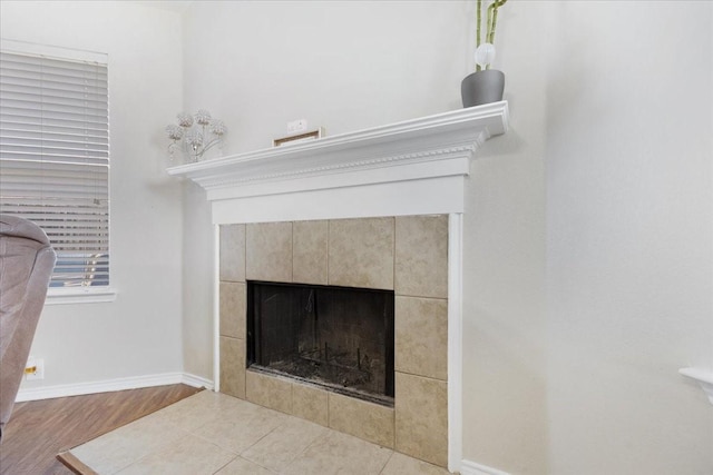 interior details with a fireplace and baseboards