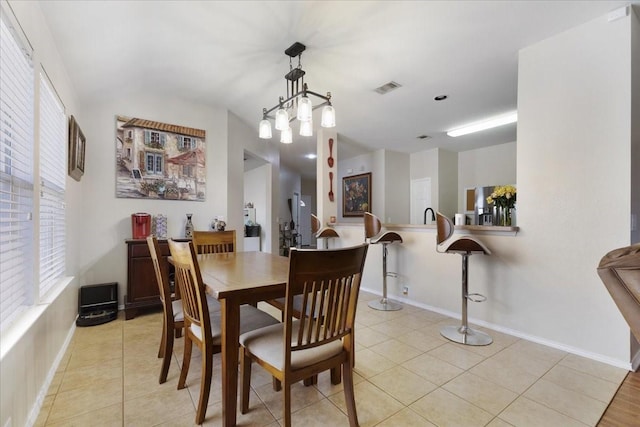 dining area with baseboards, visible vents, and light tile patterned flooring