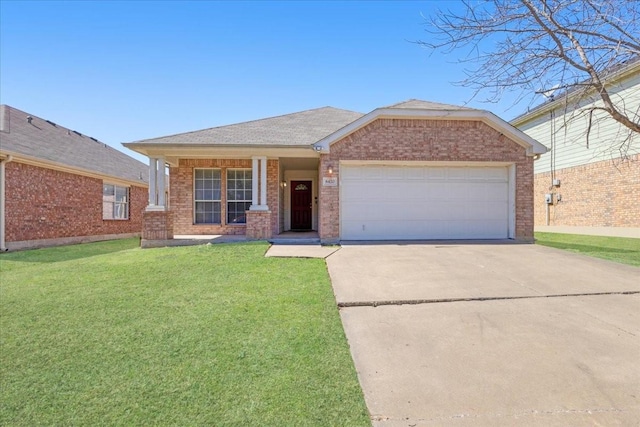 view of front of house with a front yard, brick siding, driveway, and an attached garage