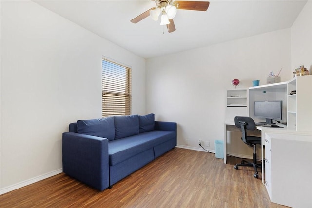 office area featuring a ceiling fan, baseboards, and wood finished floors