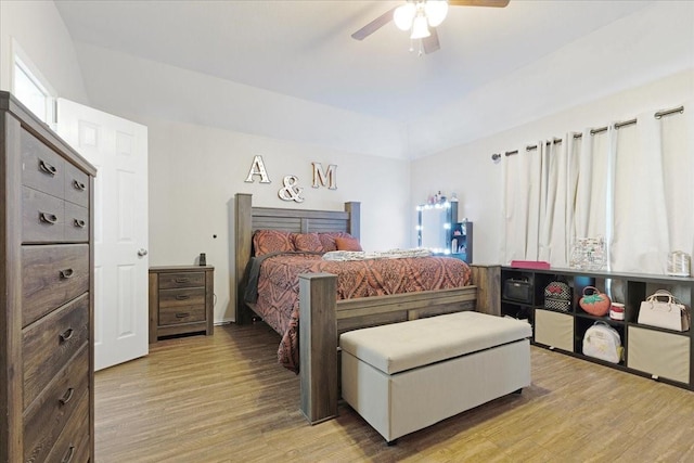 bedroom with a ceiling fan and light wood-style floors