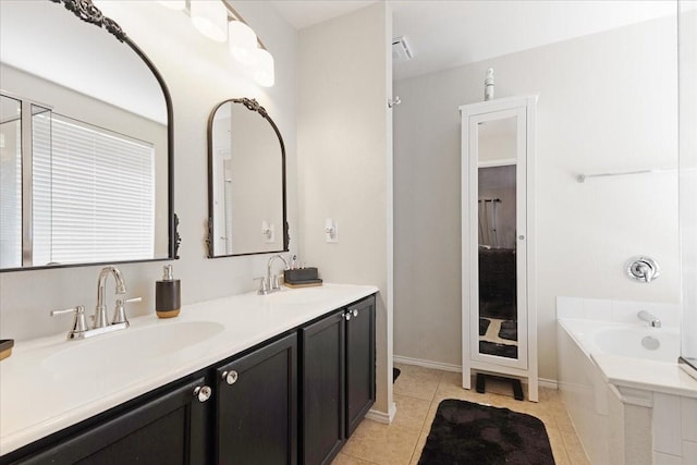 full bathroom with a bath, double vanity, a sink, and tile patterned floors