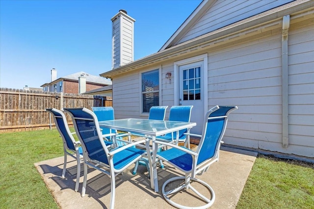 view of patio featuring outdoor dining space and fence