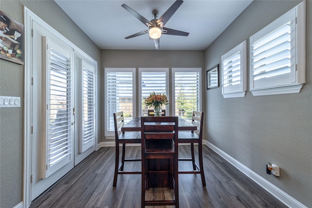 dining room with a textured wall, dark wood-style flooring, ceiling fan, and baseboards