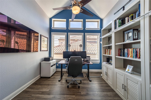 office area with dark wood-style floors, vaulted ceiling, baseboards, and a ceiling fan