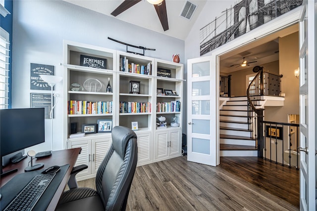 office area with dark wood-type flooring, vaulted ceiling, visible vents, and ceiling fan