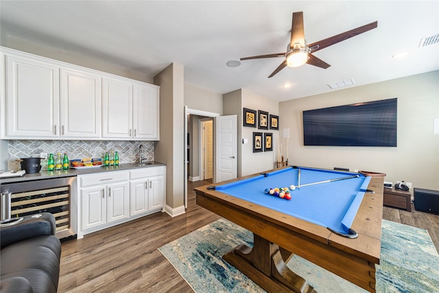 game room featuring wine cooler, visible vents, wood finished floors, wet bar, and billiards