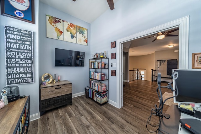 interior space featuring dark wood-style flooring, ceiling fan, and baseboards