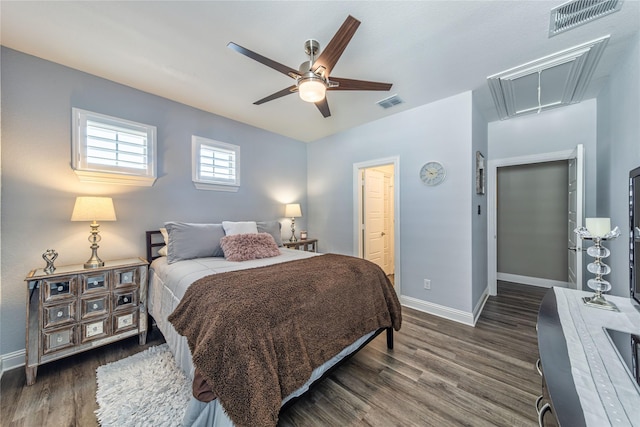 bedroom with visible vents, wood finished floors, and attic access