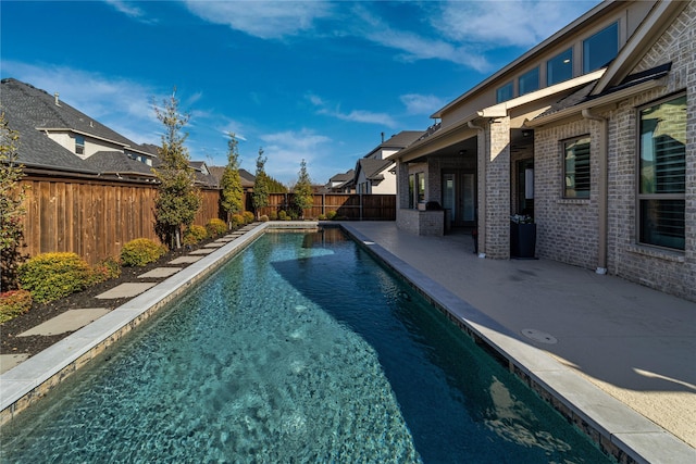 view of pool featuring a patio, a fenced backyard, a residential view, and a fenced in pool