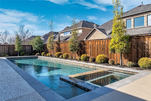 view of pool featuring a fenced backyard, a residential view, and a pool with connected hot tub