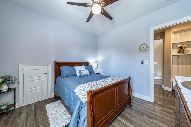 bedroom with wood finished floors, a ceiling fan, and baseboards