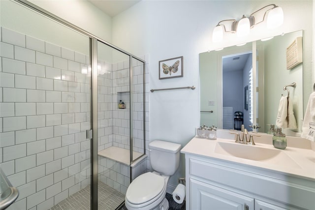 full bath featuring toilet, a stall shower, and vanity