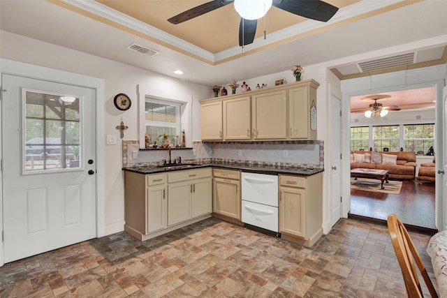 kitchen featuring visible vents, a tray ceiling, and cream cabinetry