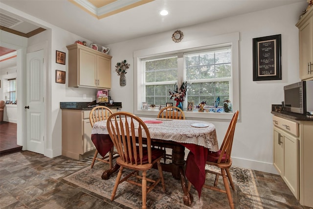 dining area featuring crown molding, recessed lighting, visible vents, stone finish floor, and baseboards