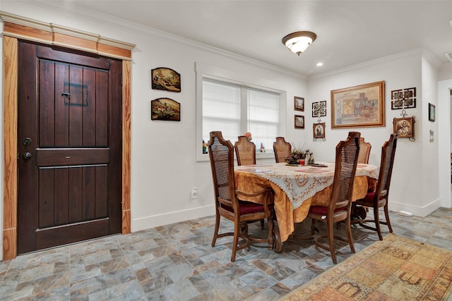 dining space featuring baseboards, stone finish floor, and crown molding