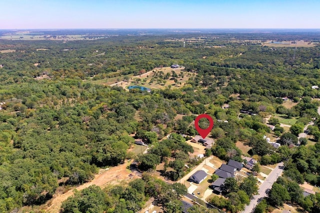 birds eye view of property with a wooded view