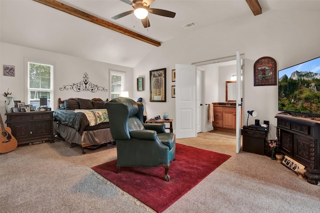 carpeted bedroom with vaulted ceiling with beams, connected bathroom, visible vents, and a ceiling fan