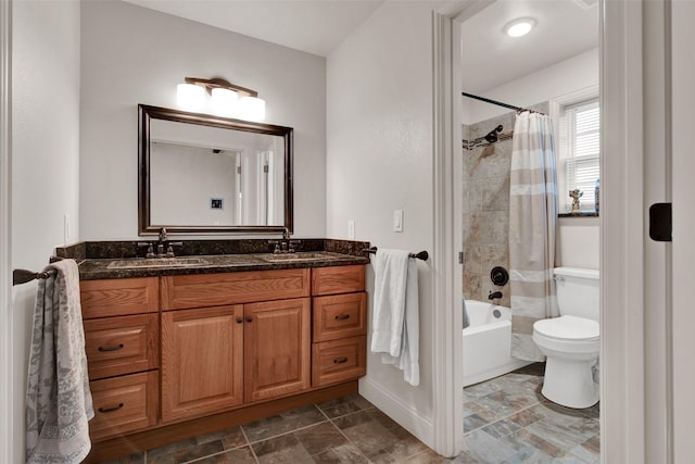 bathroom featuring toilet, shower / bath combination with curtain, double vanity, and a sink