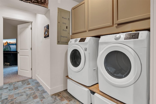 clothes washing area with cabinet space, stone finish flooring, baseboards, and independent washer and dryer