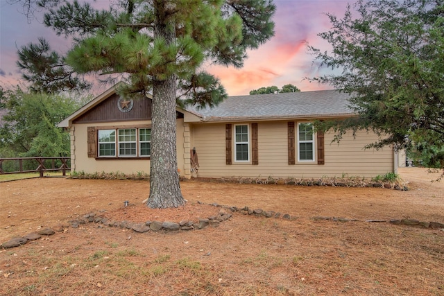 ranch-style house with fence