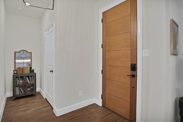 entryway with wood finish floors and baseboards