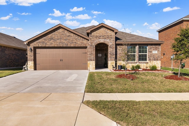 view of front of house featuring an attached garage, brick siding, stone siding, concrete driveway, and a front lawn