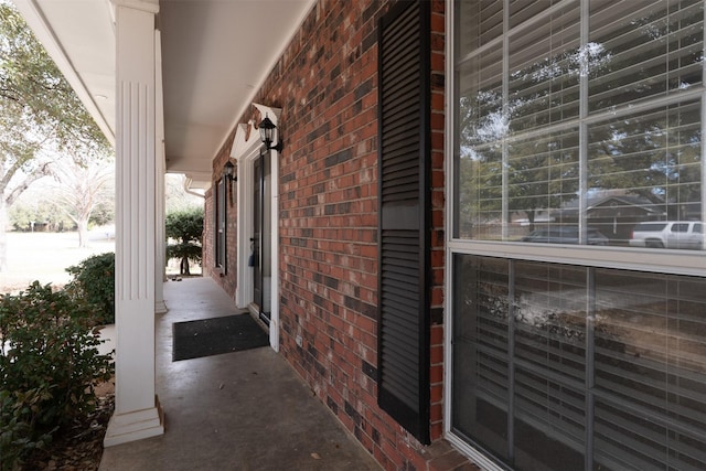 exterior space featuring a porch and brick siding