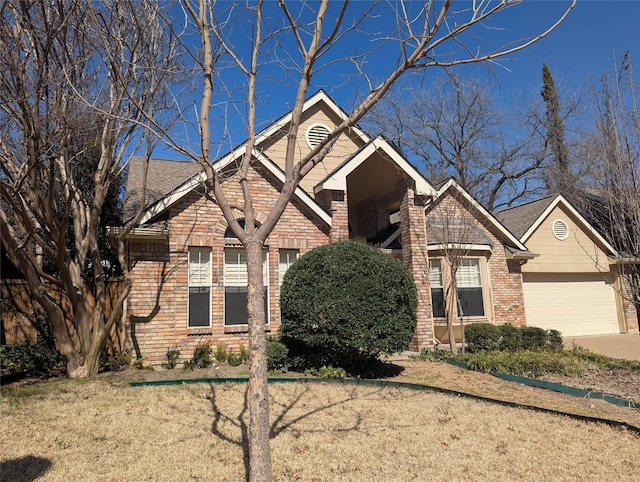 view of front of house featuring a garage, a front yard, and brick siding