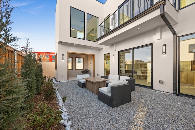 back of property with a patio, fence, a balcony, and stucco siding