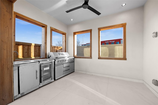 interior space featuring a ceiling fan, recessed lighting, a sink, and baseboards