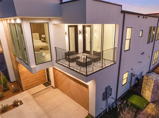 exterior space featuring a balcony and stucco siding