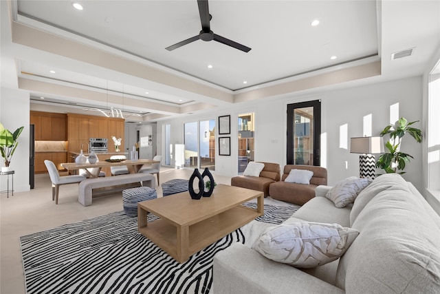 living area featuring crown molding, recessed lighting, a raised ceiling, visible vents, and a ceiling fan